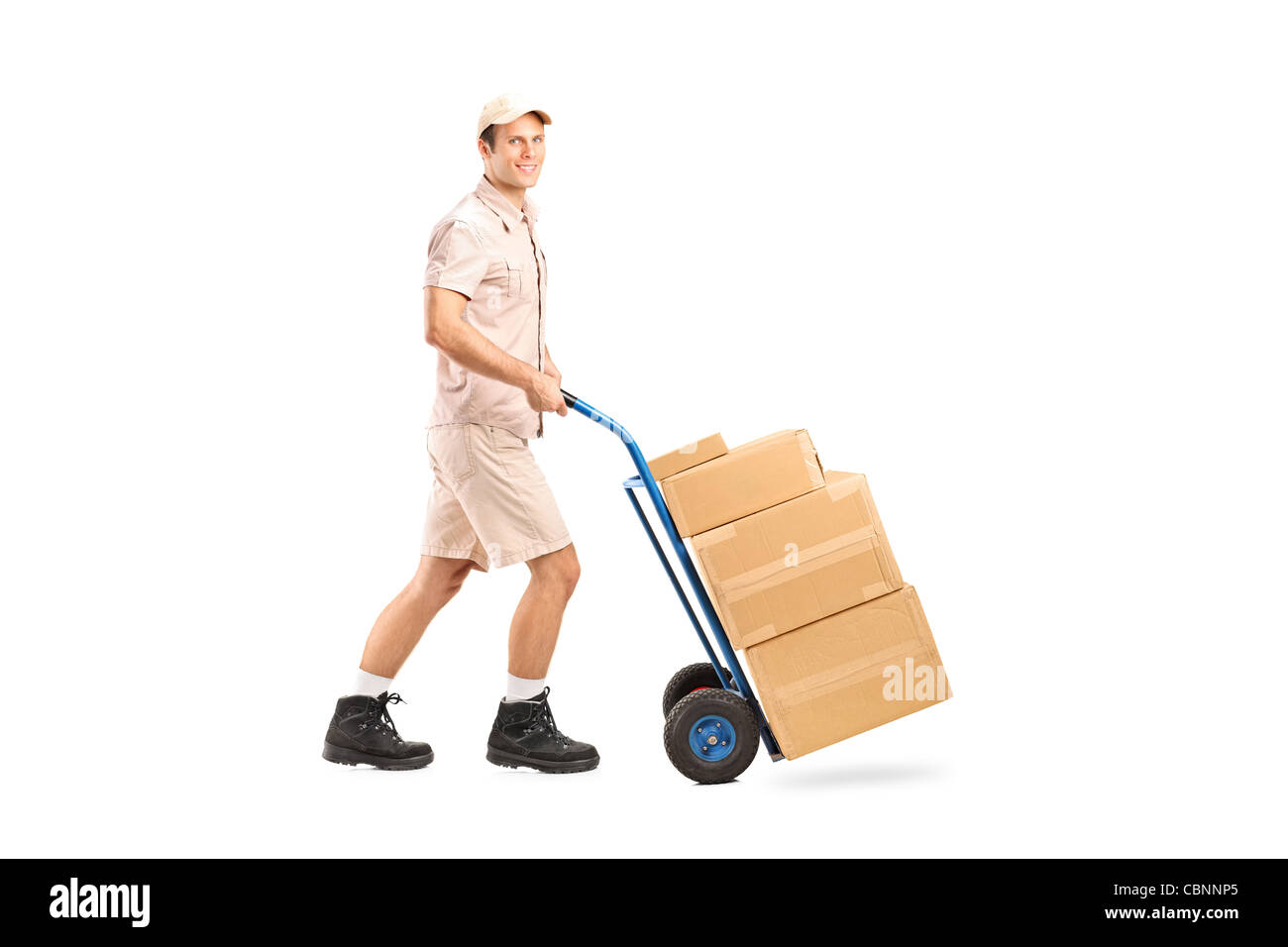 Full length portrait of a delivery boy pushing a handtruck Stock Photo