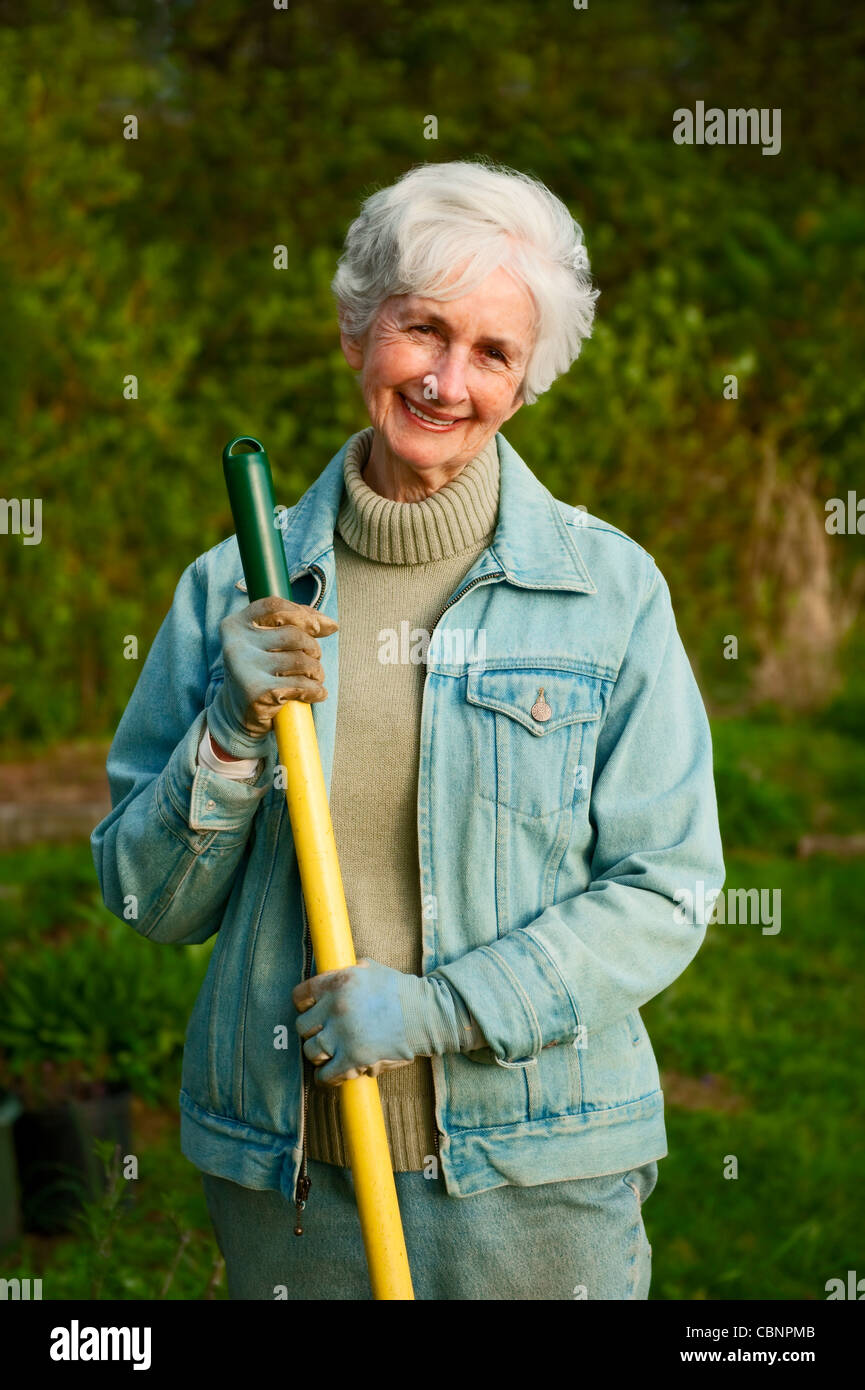 Portrait of a senior woman working in the garden Stock Photo - Alamy