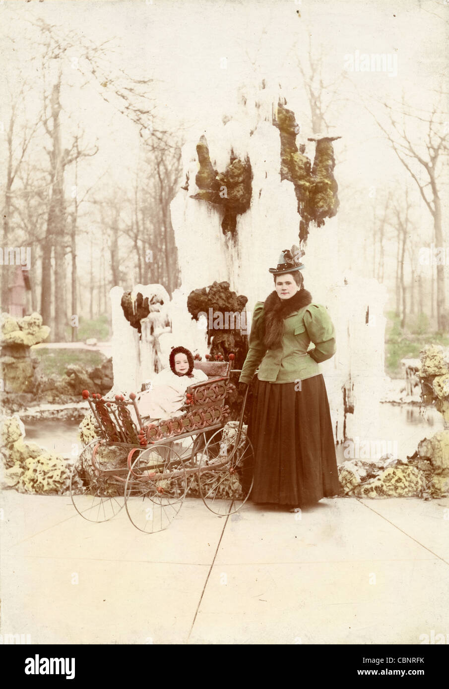 Victorian Mother & Infant in Wicker Carriage in Winter Stock Photo
