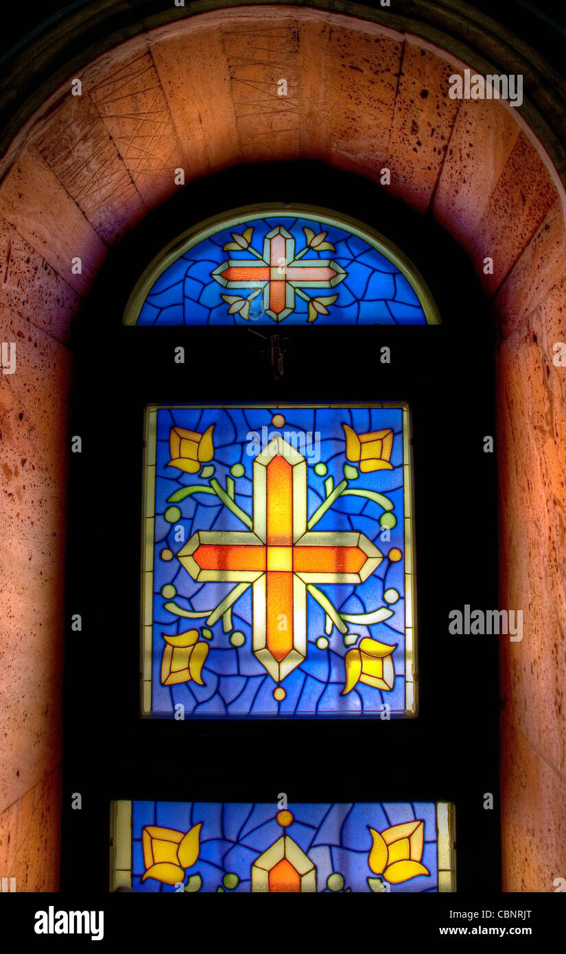colorful mosaic church window lighted from behind Stock Photo