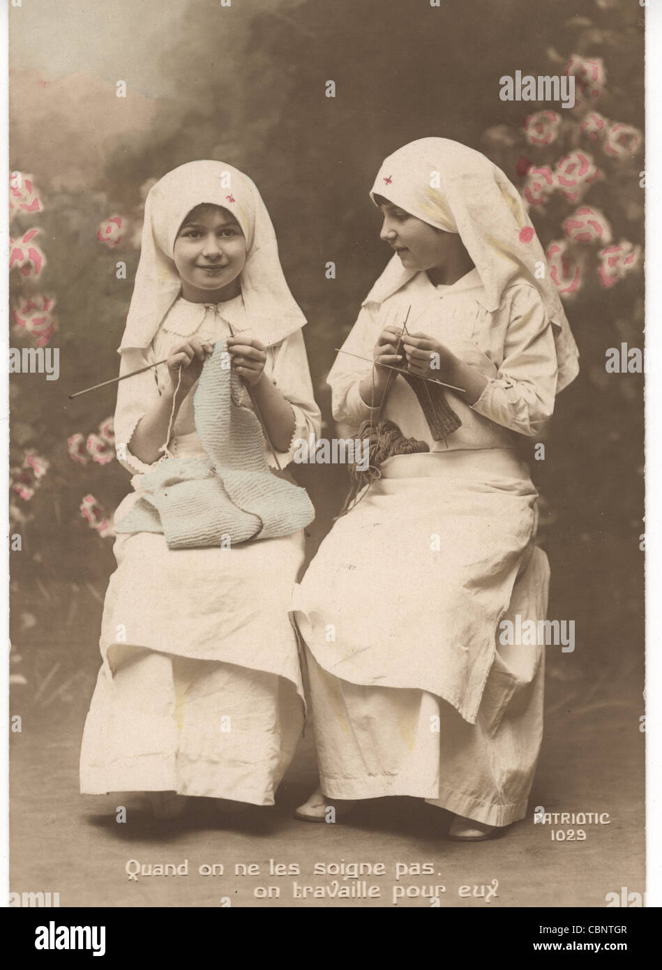 Two Little Girl Nurses Knitting Clothes Stock Photo