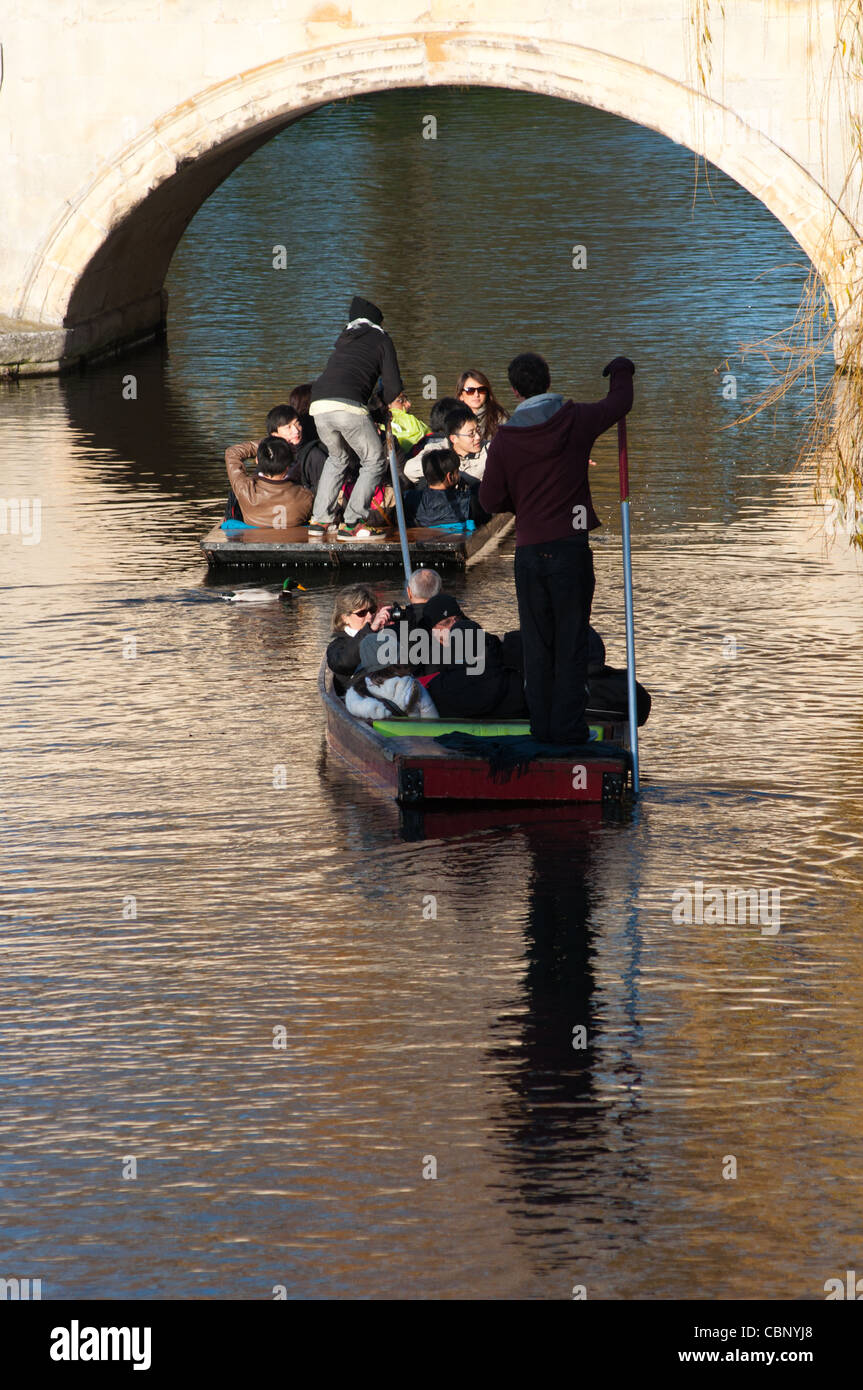 Punters going under Trinity bridge on river Cam, Cambridge, England. Stock Photo