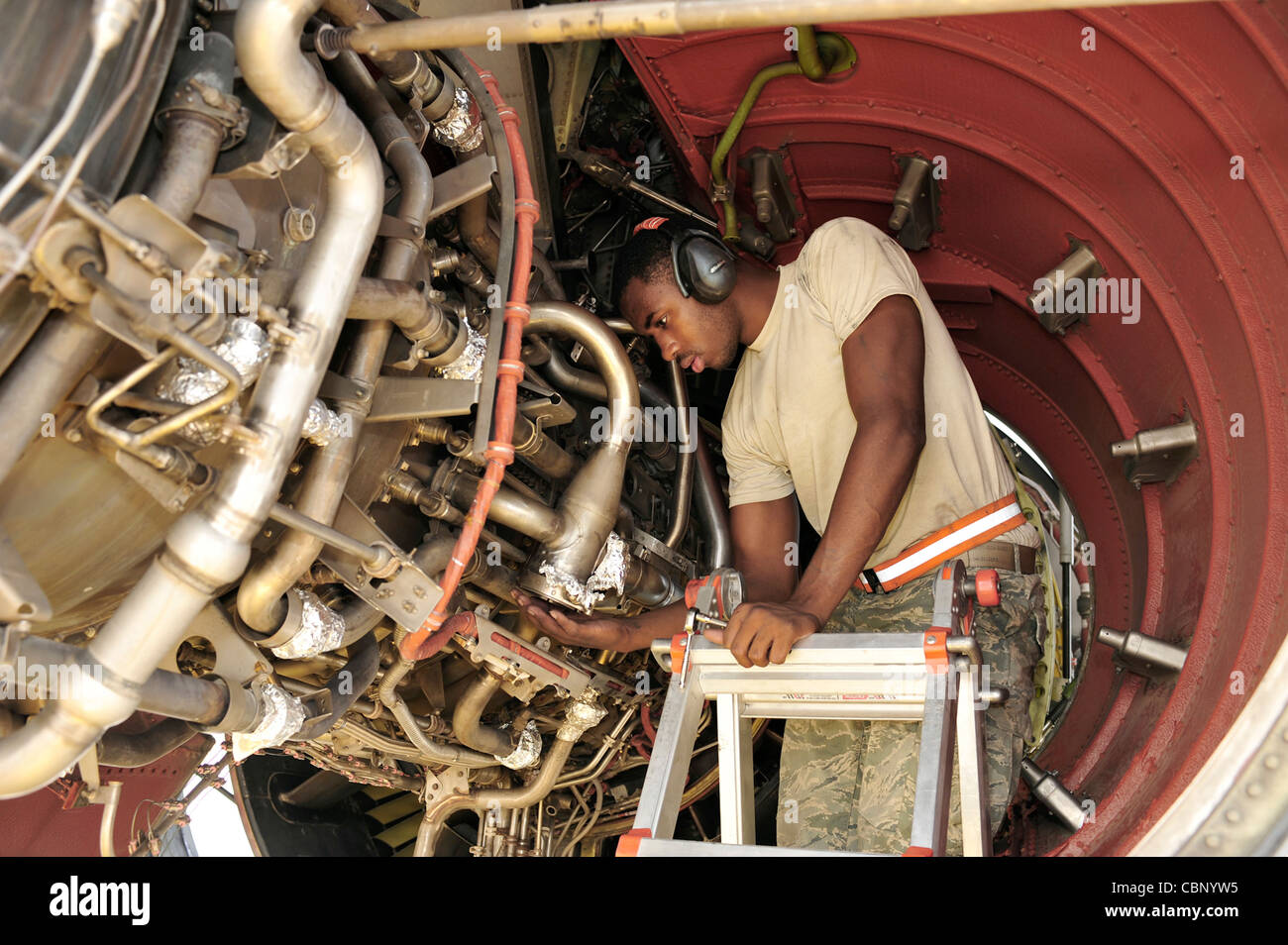 Airman 1st Class Mareguis Killebrew checks for leaks on a KC-10 Extender engine Aug. 29, 2009, at an air base in Southwest Asia. Airman Killebrew is assigned to the 380th Expeditionary Maintenance Squadron, and is deployed from Travis Air Force Base, Calif. Stock Photo