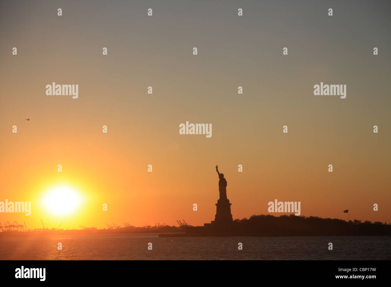 Sunset with Statue of Liberty Stock Photo