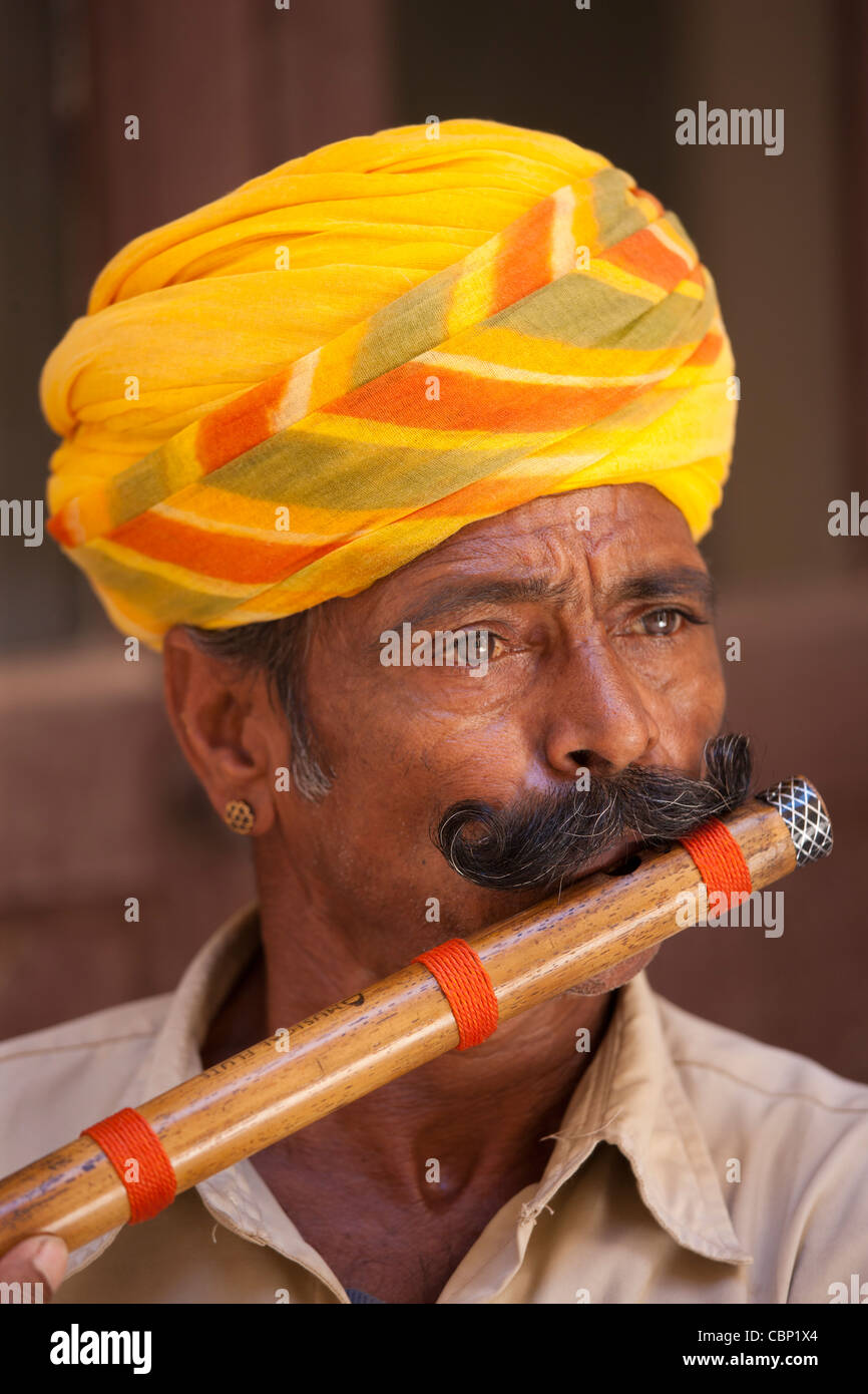 Hindu musician playing flute wind instrument at Mehrangarh Fort at Jodhpur in Rajasthan, Northern India Stock Photo