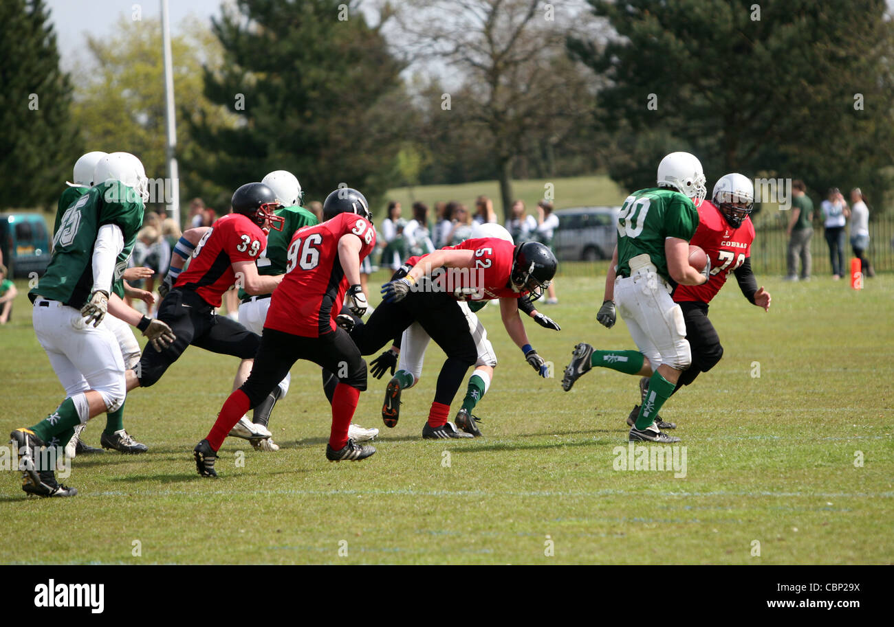 An American football player makes a diving tackle on a member of the
