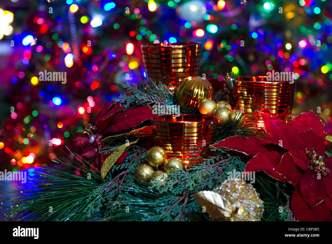 centerpiece Candle set a front of Christmas tree lights Stock Photo