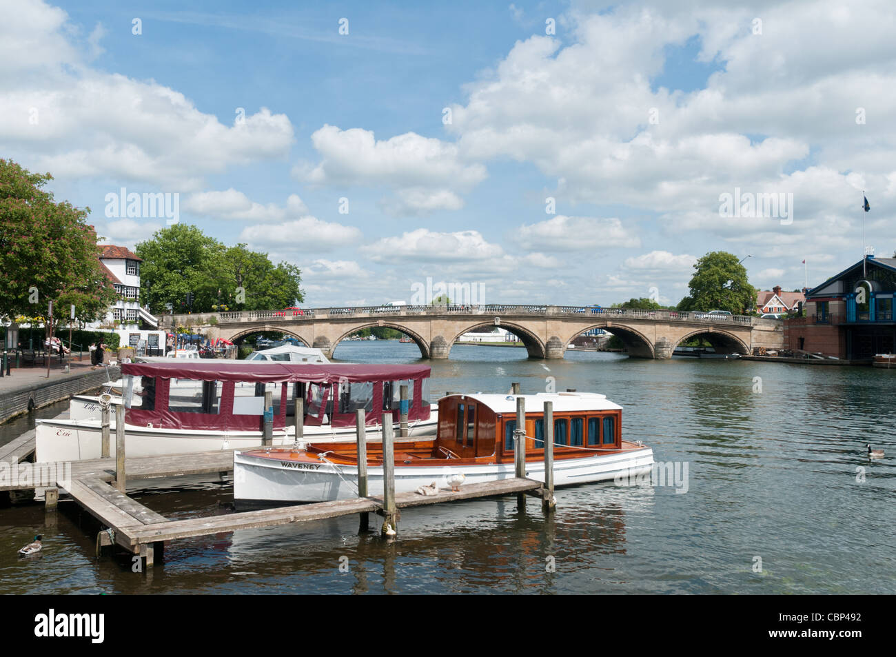 Pleasure boats moored at Henley-on-Thames with the five arched Henley Bridge in the background Stock Photo