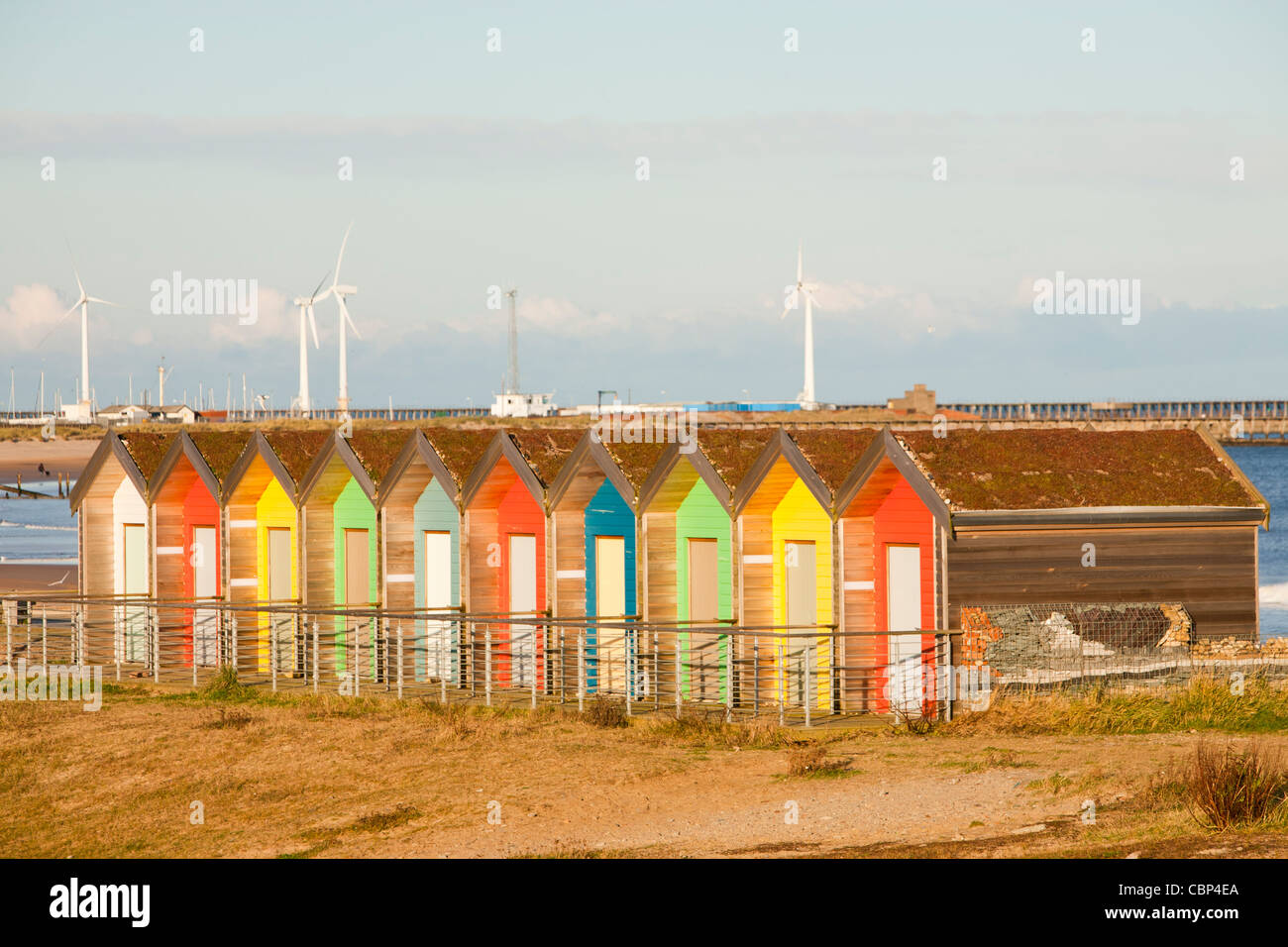 Colourful Traditional British Seaside Beach Huts On The Beach In