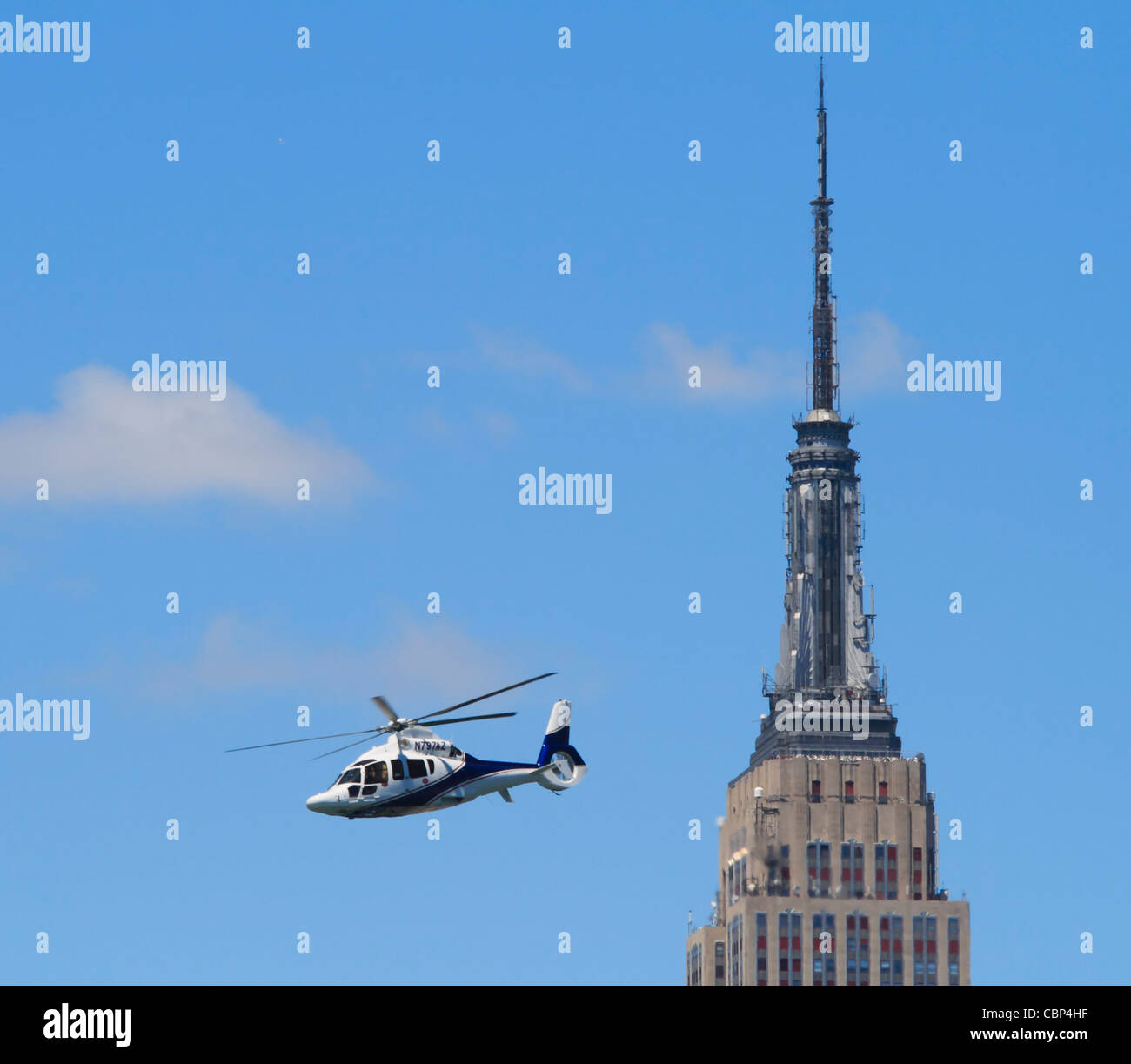 Eurocopter EC 155 B1, number N797AZ, flying past the Empire State Building in New York. Stock Photo
