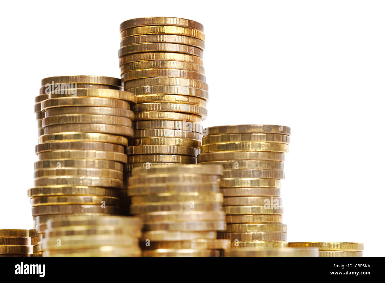 Golden coins stacks close up on white background Stock Photo - Alamy