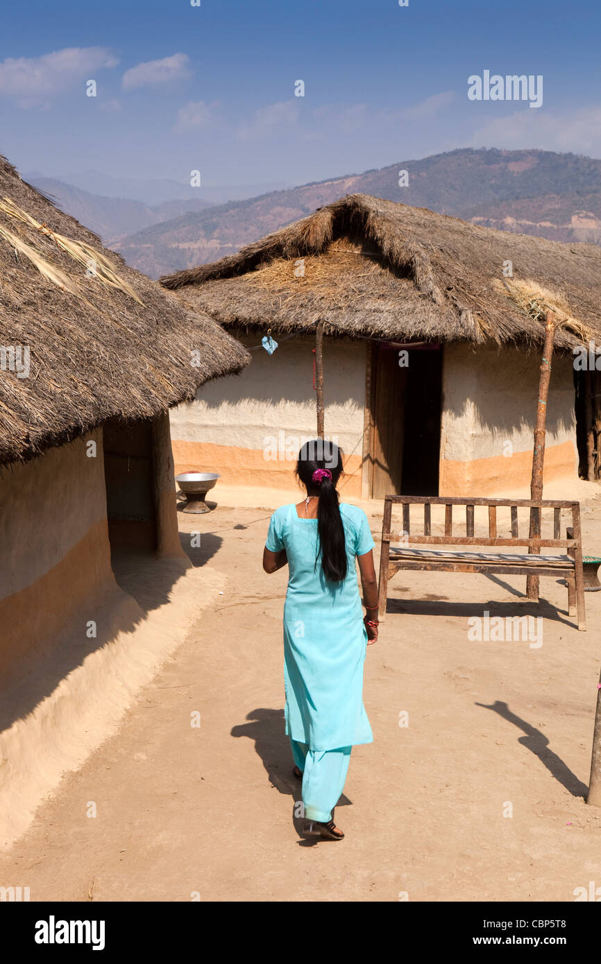 India, Manipur, Lairouching Hills, woman in compound of local wooden ...