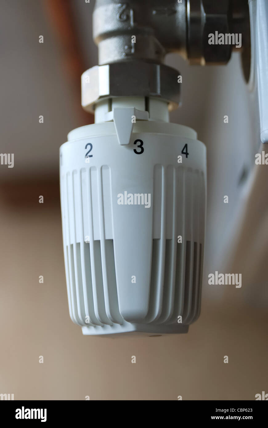 Thermostatic radiator valve set to optimal temperature. Close up Stock