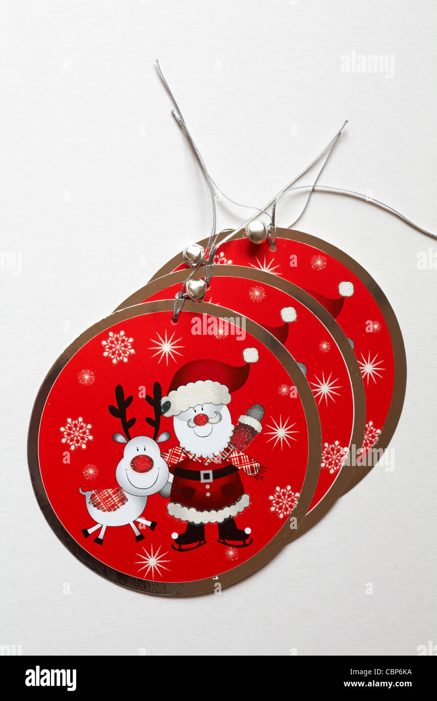 luxury red Christmas gift tags with Santa Claus Father Christmas and Rudolph the Red nosed Reindeer on isolated on white background Stock Photo