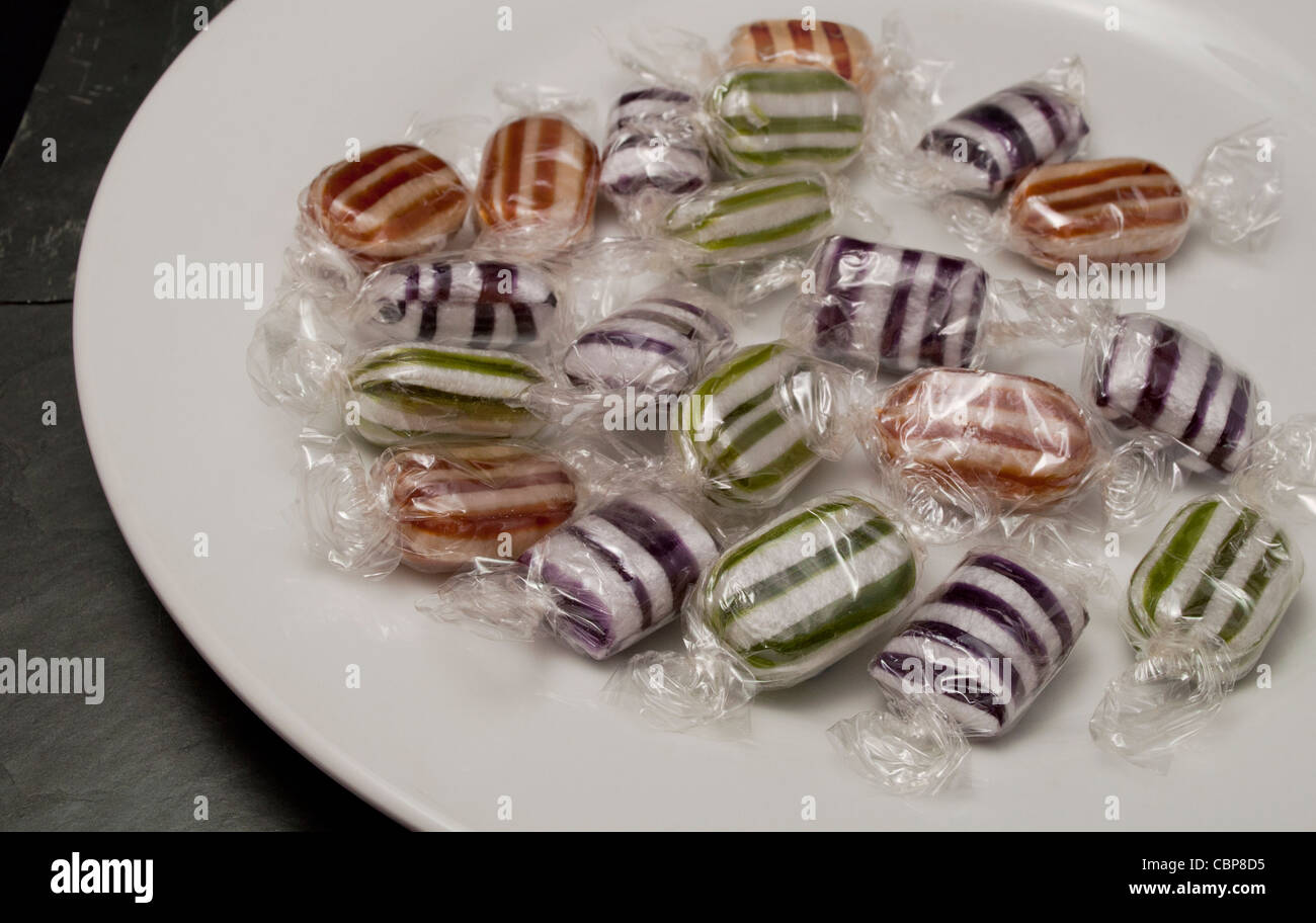 Plate of stripy boiled sweets or candy Stock Photo