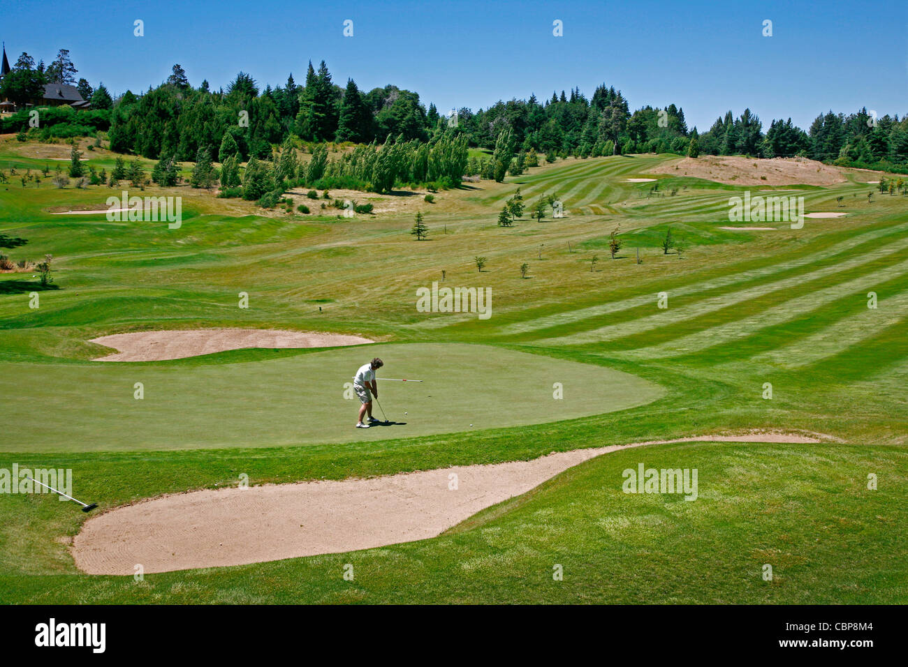 Man playing golf at Llao Llao Hotel near Bariloche, Patagonia. Argentina. Stock Photo