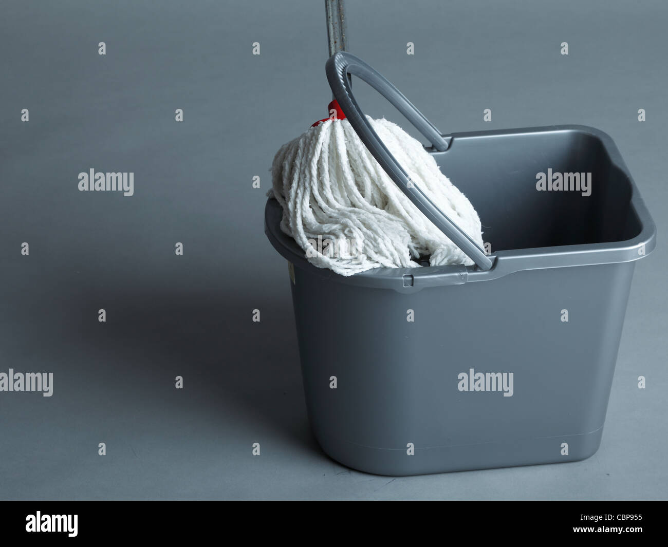 Industrial mop and bucket on grey background Stock Photo Alamy