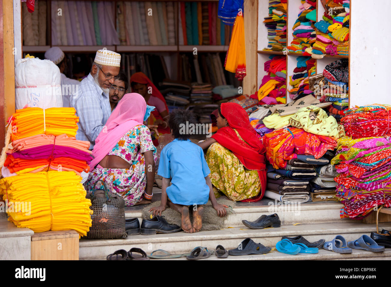Indian family shopping for children's clothes in old town in Udaipur