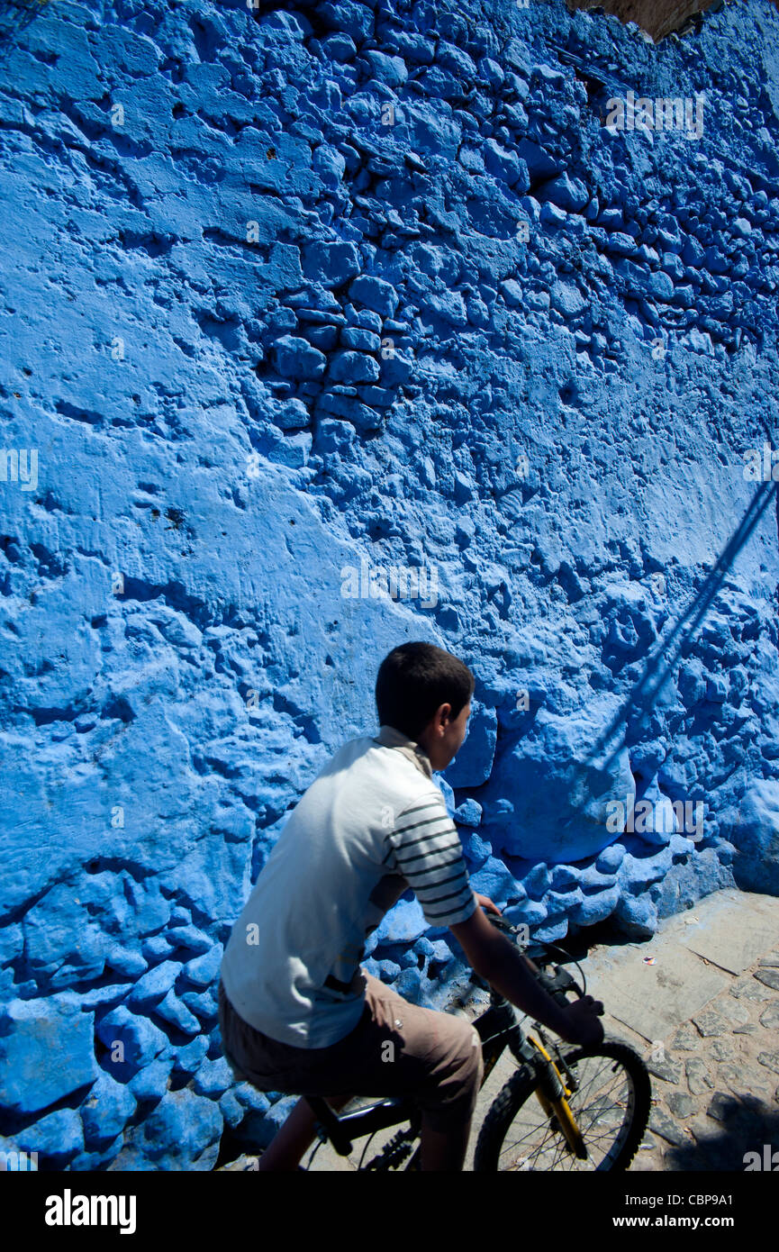 Young boy riding a Bycicle,Chefchaouen, Rif region. Morocco.North Africa. Stock Photo