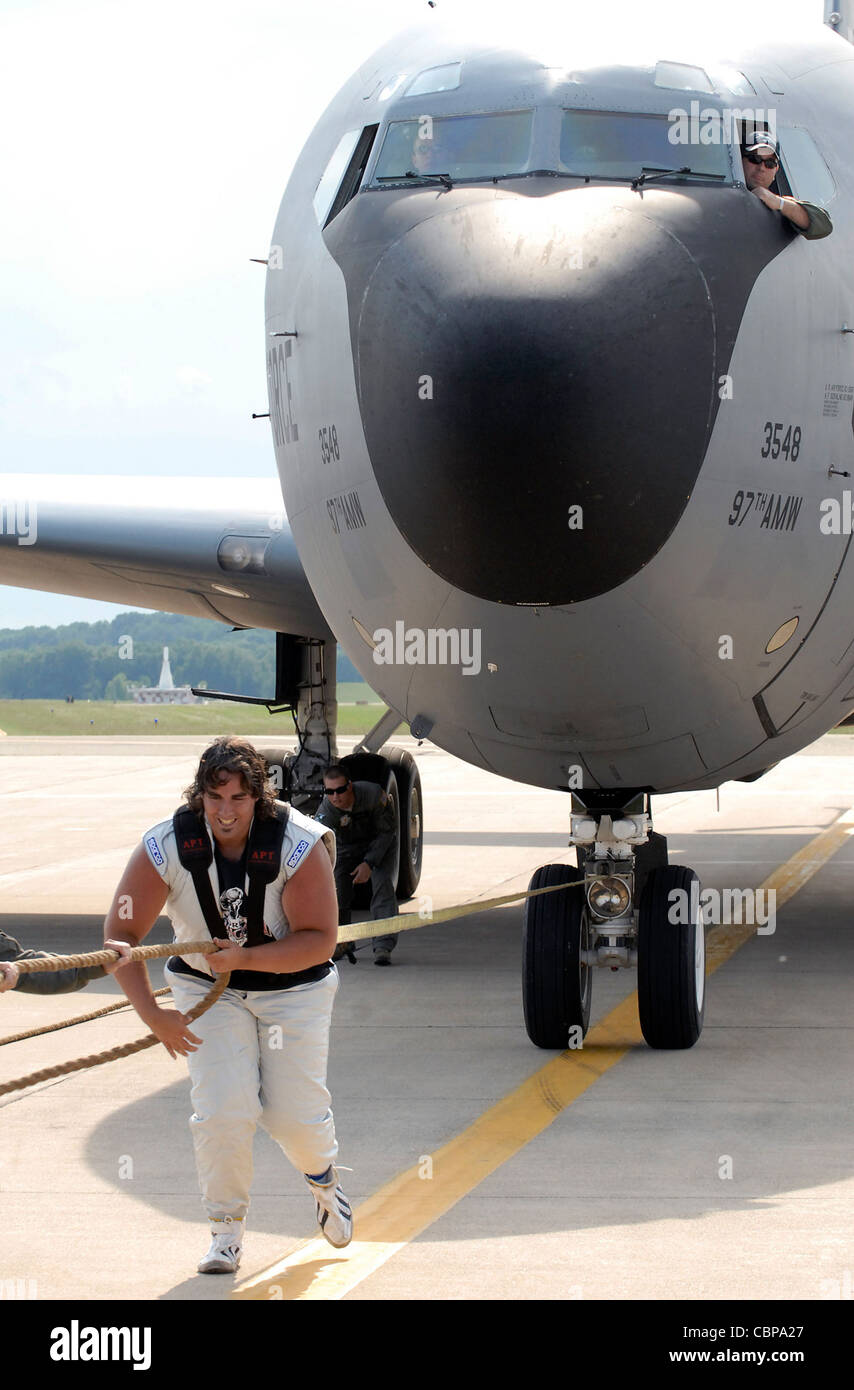 Strongman Mark Kirsch pulls a 140,000 pound KC-135 Stratotanker July 1, 2011, during the Battle Creek Field of Flight and Balloon Festival in Battle Creek, Mich. The KC-135 is assigned to the 54th Air Refueling Squadron at Altus Air Force Base, Okla., and was the first Air Force plane to ever be pulled by a strongman. Stock Photo