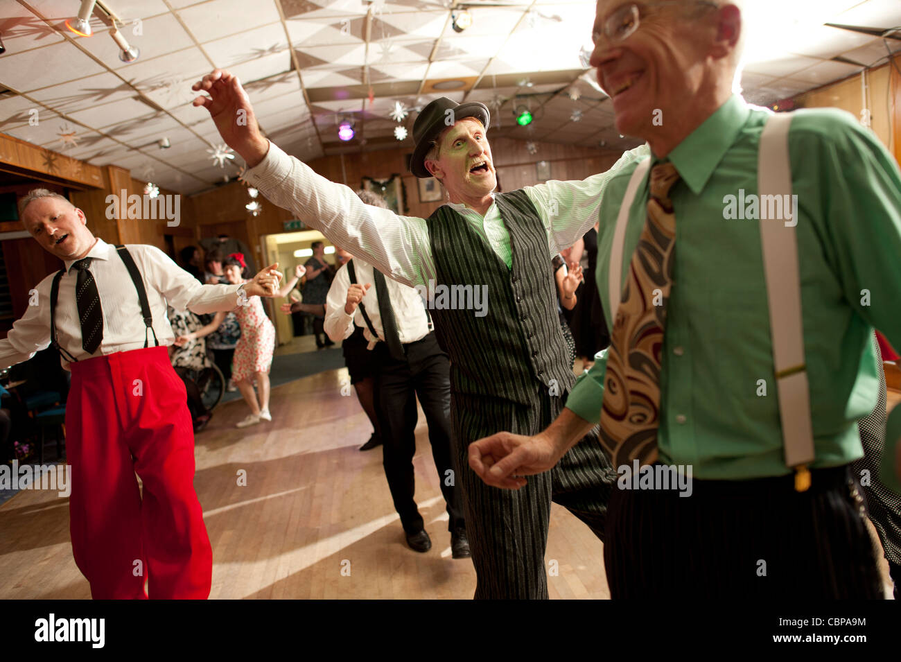 men swing dancing Lindy hopping and jiving to retro 40s 50s music at a club, UK Stock Photo