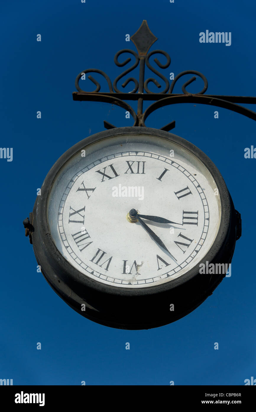 hanging old clock outdoor with half past three Stock Photo Alamy