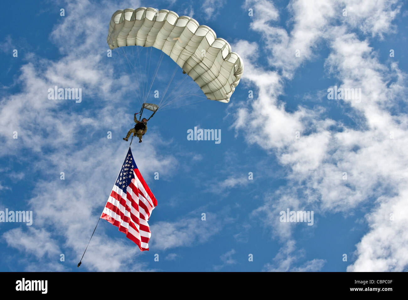 A U.S. Air Force combat controller jumps with the American flag during the 2011 Aviation Nation Open House Nov. 12, at Nellis Air Force Base, Nev. Aviation Nation celebrates 70 years of airpower in Las Vegas and the Air Force's accomplishments in air, space and cyberspace. Stock Photo