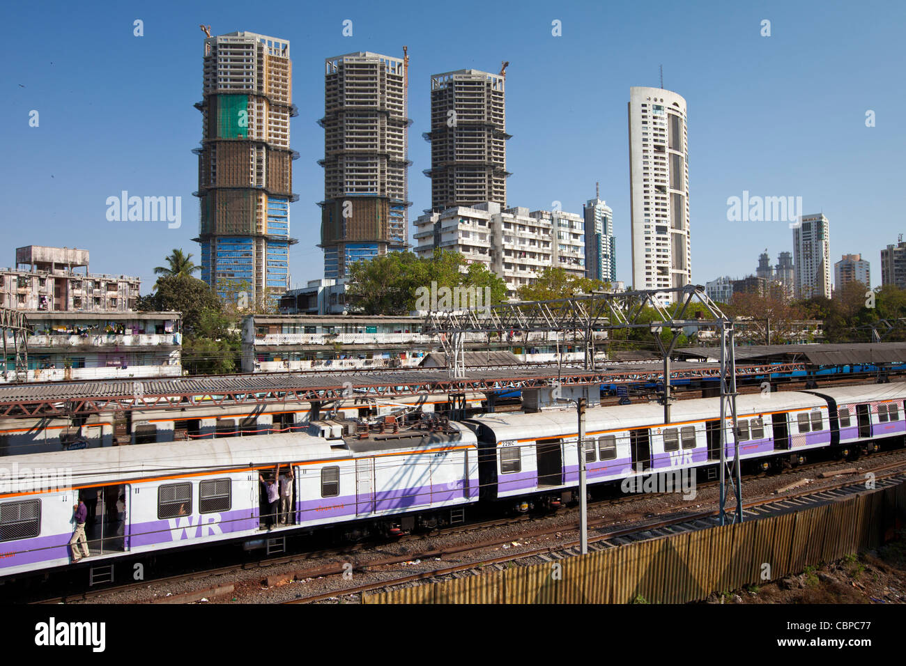 High rise developments by Mahalaxmi Station and the Western Railways train of the Mumbai Suburban Railway, India Stock Photo