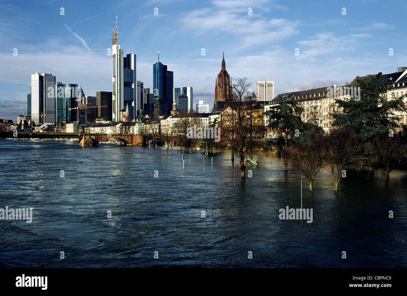 Melting snow in the south has caused the river Main to swell and flood its riverside promenade in German Frankfurt am Main. Stock Photo