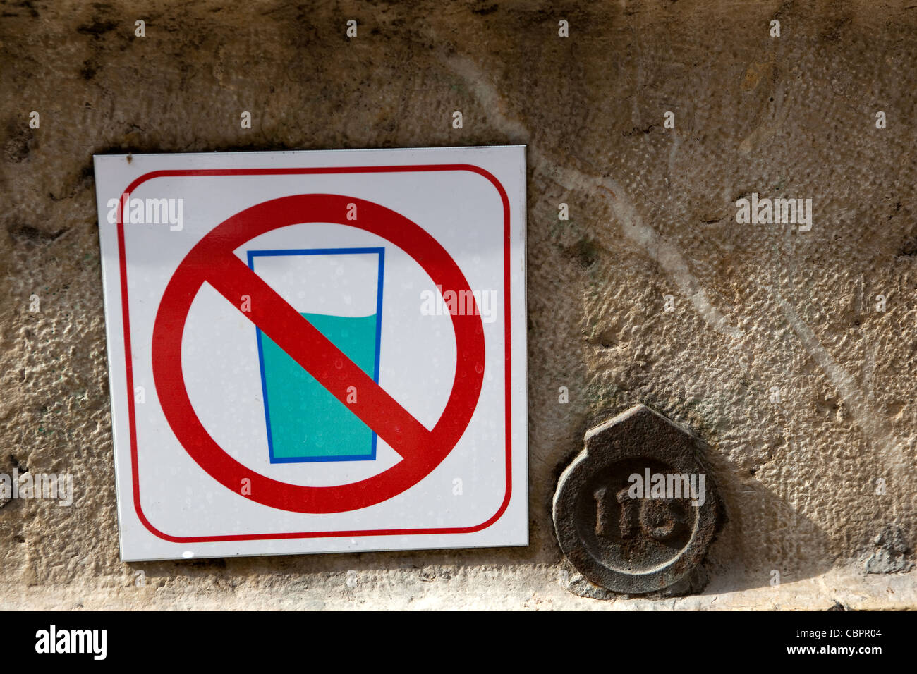 hazard signs  'Do not drink this water' , unsafe drinking water sign next to old public fountain Toulon France Stock Photo