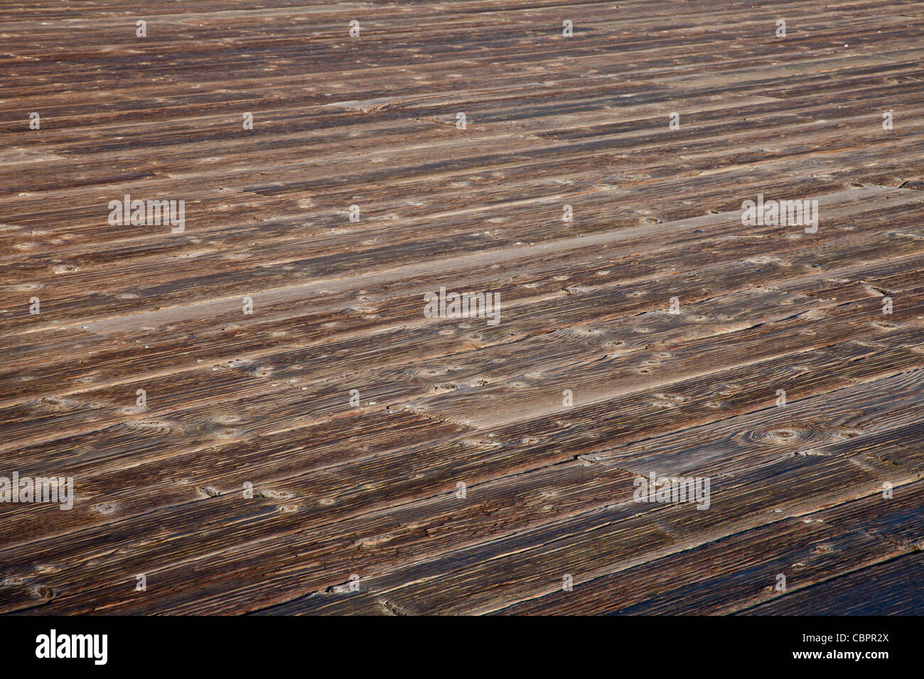 rough weathered wooden deck with diagonal plank pattern Stock Photo