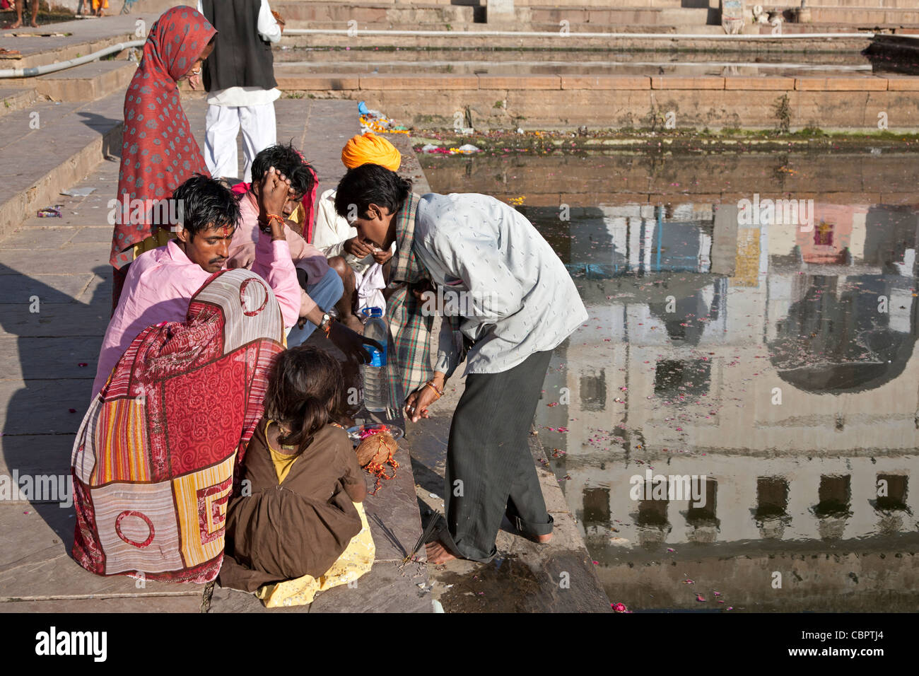 Hindu family making a ritual offering (puja). Pushkar lake. Rajasthan ...