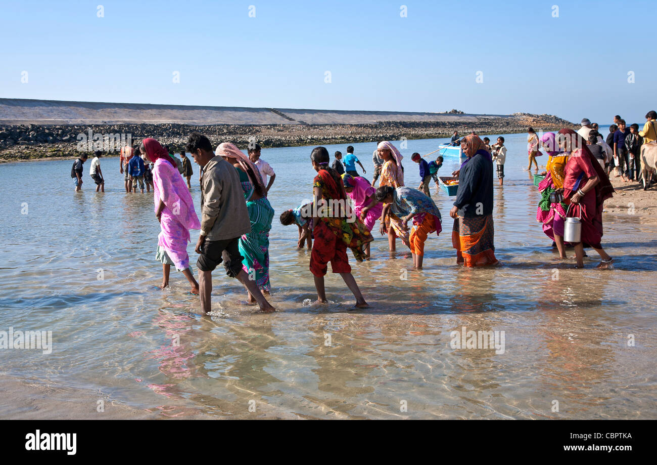Hindu pilgrims bathing in the sacred waters. Dwarka. Gujarat. India Stock Photo