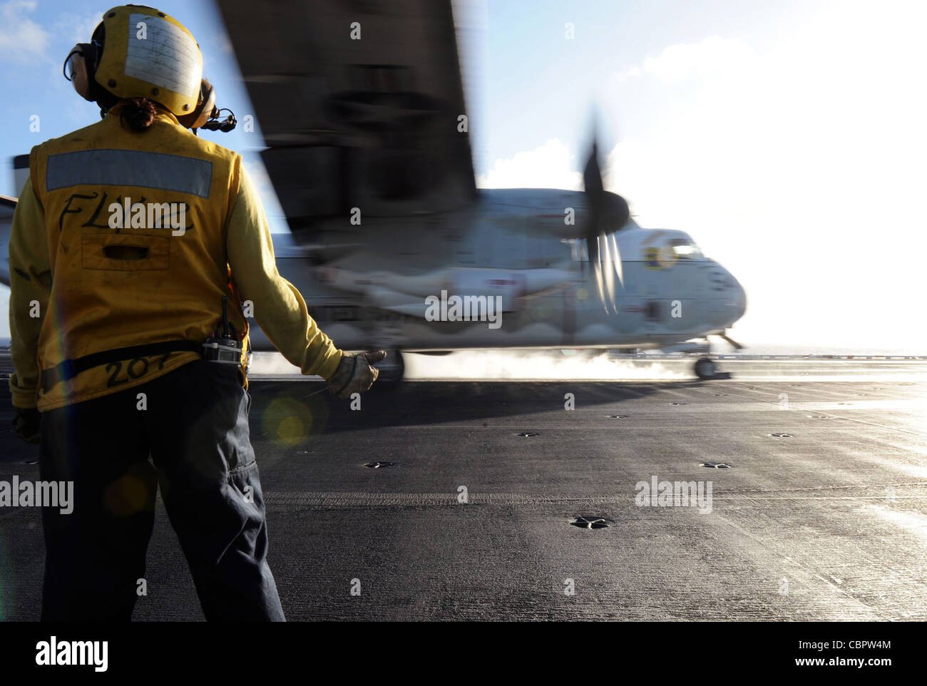 ATLANTIC OCEAN (Dec. 7, 2011) Aviation Boatswain's Mate (Handling) 3rd Class Clarissa K. Quick signals to a C-2 Greyhound, assigned to Fleet Logistics Support Squadron (VRC) 40, as it launches from the flight deck of the aircraft carrier USS George H.W. Bush (CVN 77). George H.W. Bush and the embarked Carrier Air Wing (CVW) 8 conducted the fly-off of fixed wing aircraft as the ship completed its first combat deployment. Stock Photo