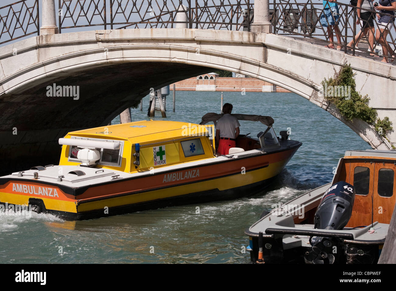 Ambulance boat going under a bridge on the canals of Venice, Italy. Stock Photo