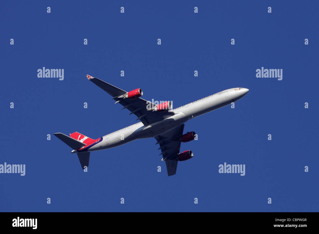 Virgin Atlantic Airbus A340-600 G-VOGE ' Cover Girl ' in flight : clear sky Stock Photo