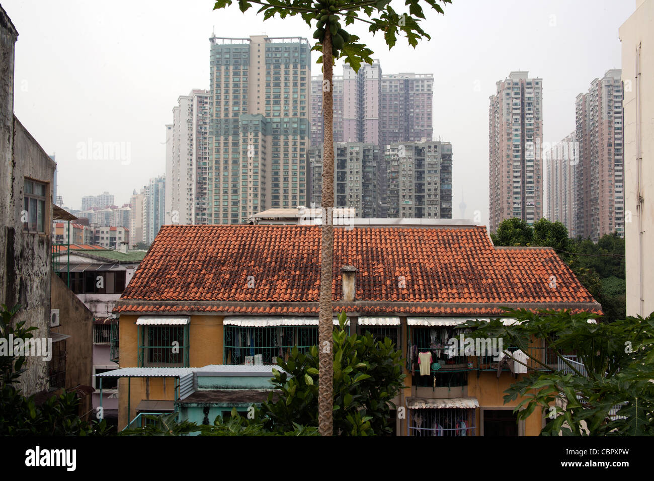 High rise flats behind colonial style house in Taipa Macau Stock Photo