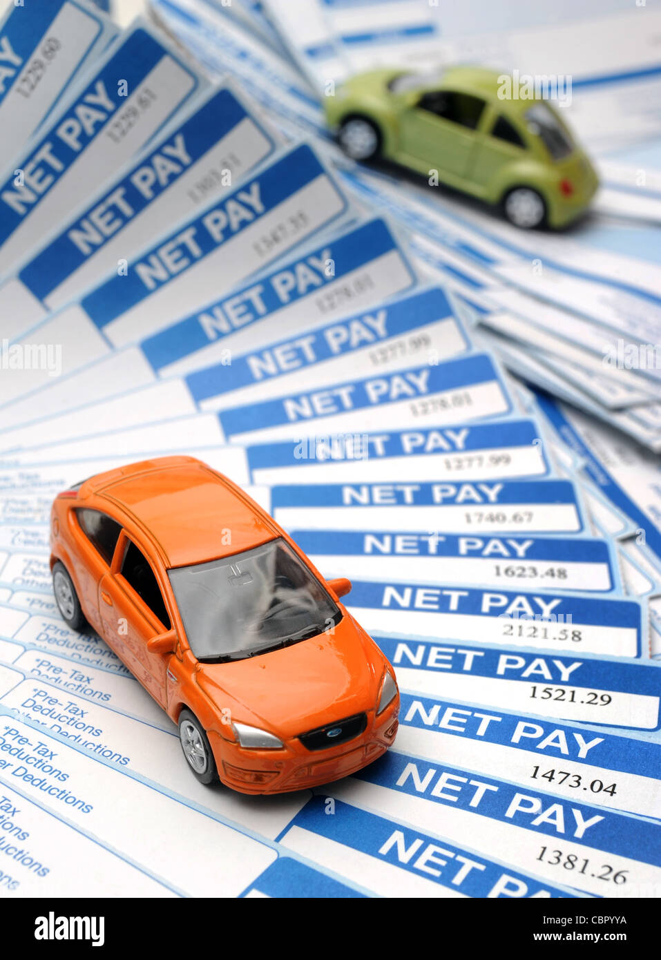 BRITISH PAYSLIPS WITH MODEL CARS RE INCOMES WAGES JOBS RISING INFLATION BILLS HOUSEHOLD BUDGETS SALARIES NET PAY MONEY ETC UK Stock Photo