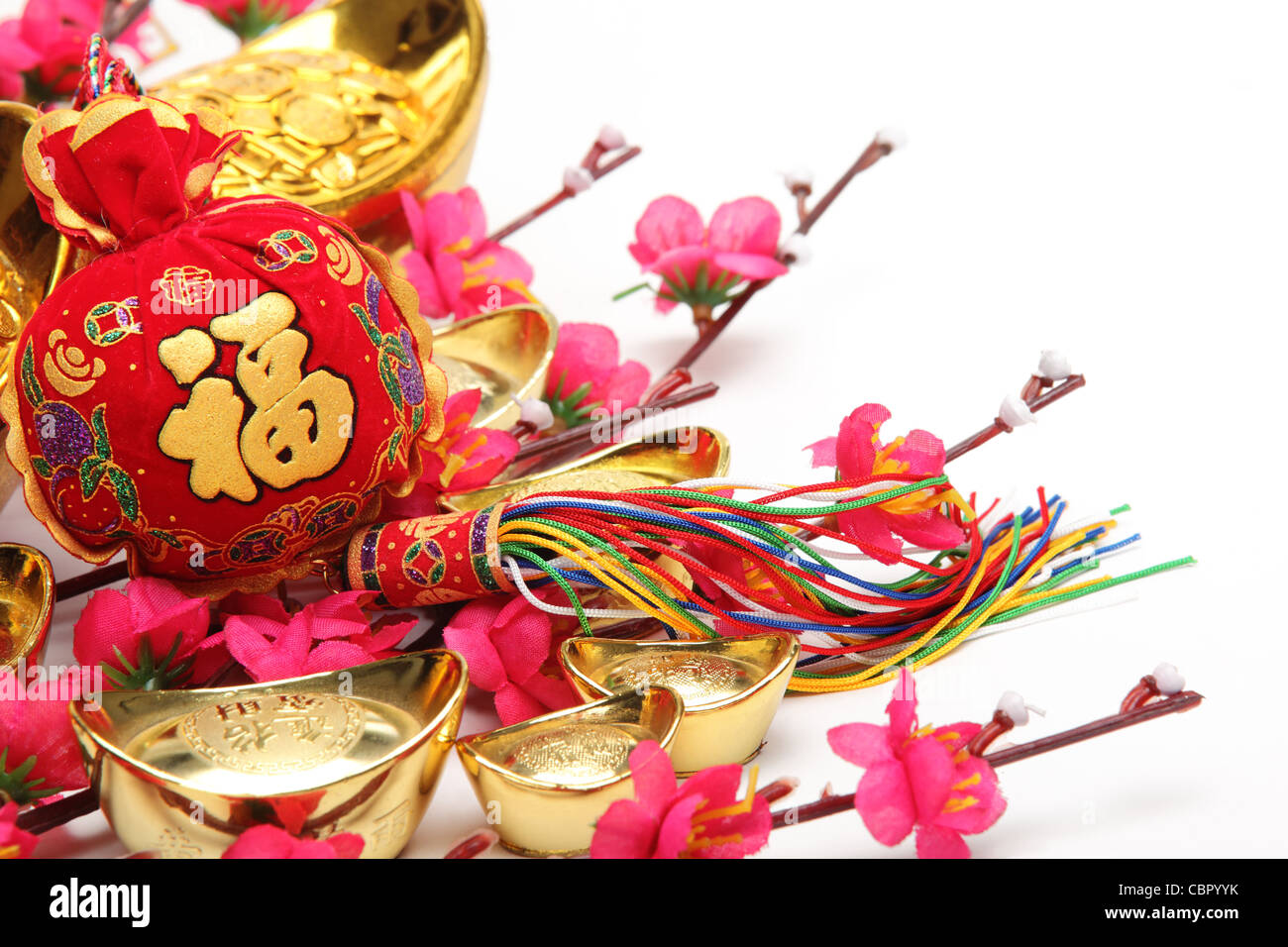 Chinese New Year Decorations,Closeup on money bag with gold ingots and plum blossom. Stock Photo