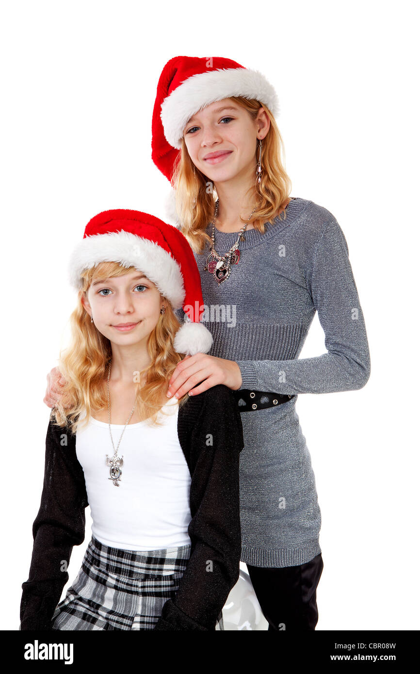 Two girl with christmas hat posing over white background Stock Photo ...