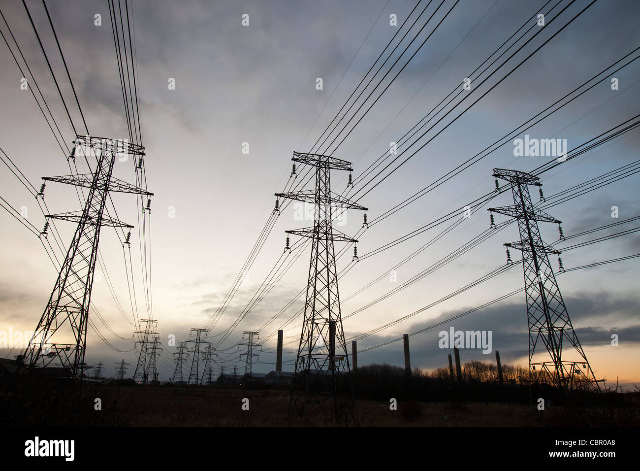 Power lines leading to an aluminium smelting plant on the outskirts of Ashington in Northumberland, UK. Stock Photo