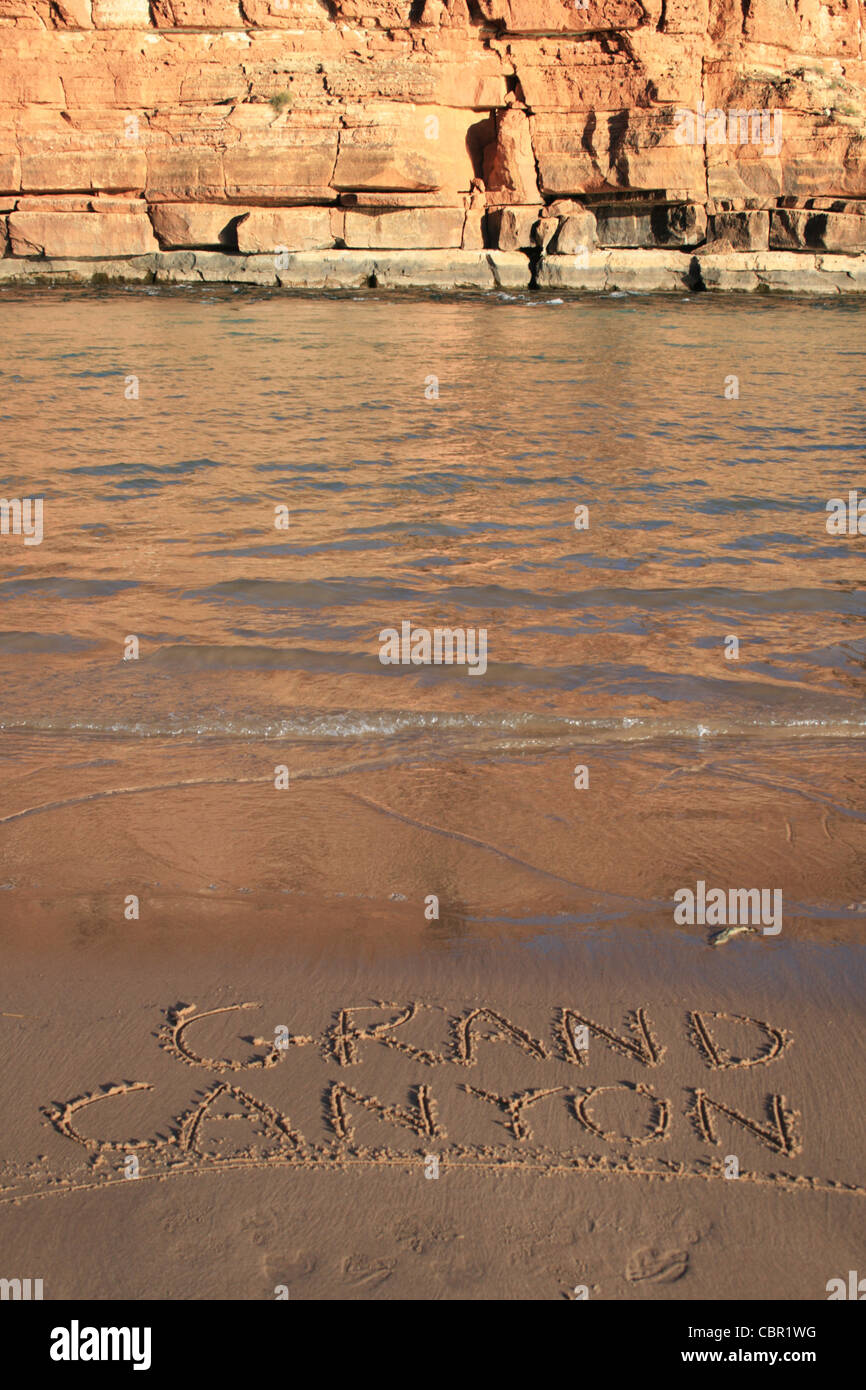 vertical image of 'Grand Canyon' written in the sand on a Colorado River bank beach Stock Photo