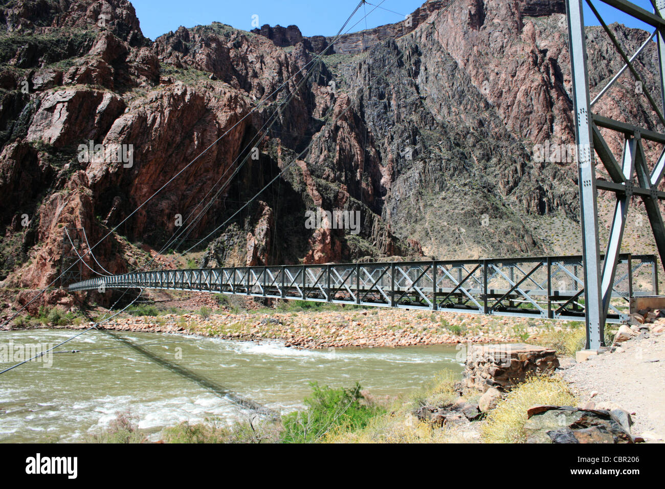 silver foot bridge across the Colorado River at the bottom of the Grand Canyon, Arizona Stock Photo