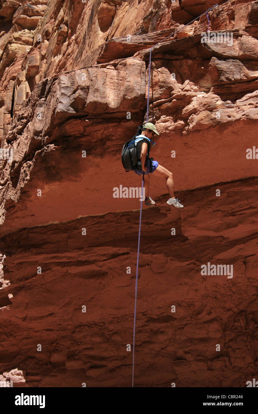 canyoneering asian woman rappels off a sandstone ledge Stock Photo - Alamy