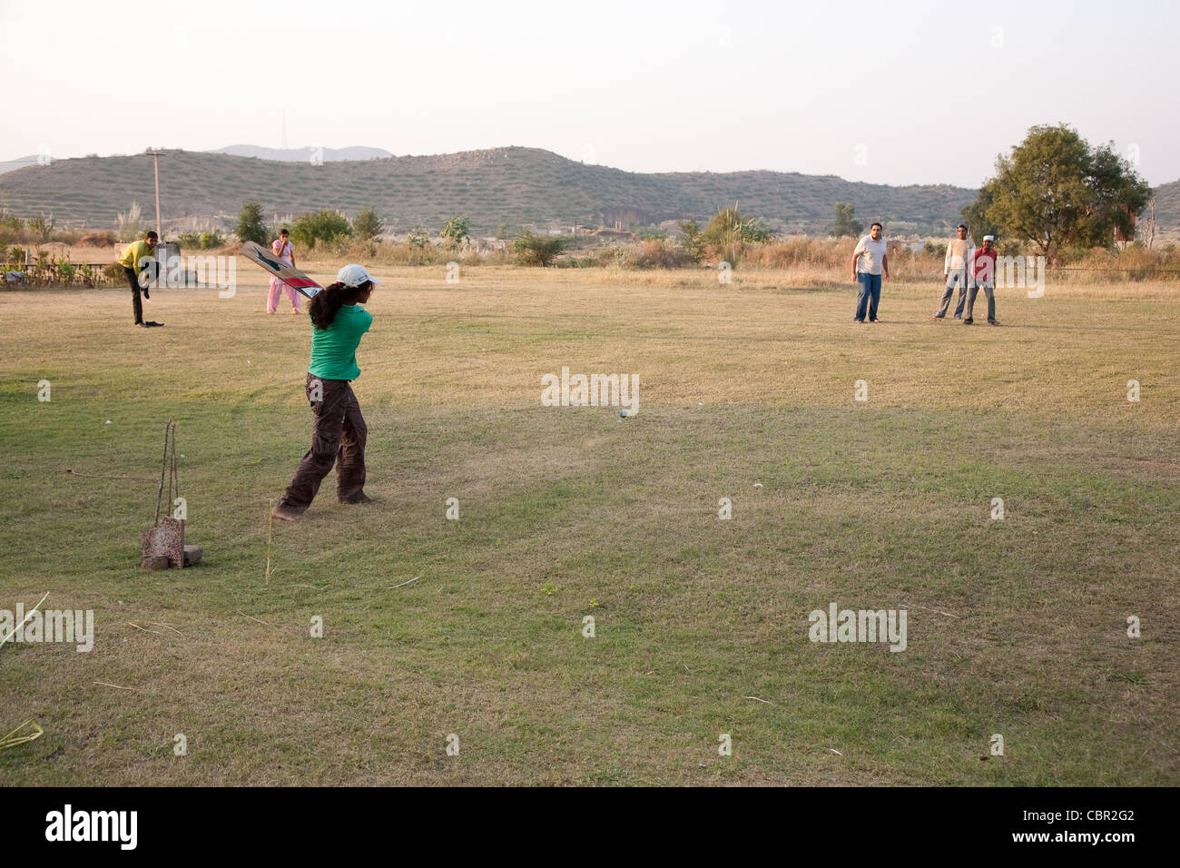 Children and staff playing cricket on a field trip from the Udayan Campus Stock Photo