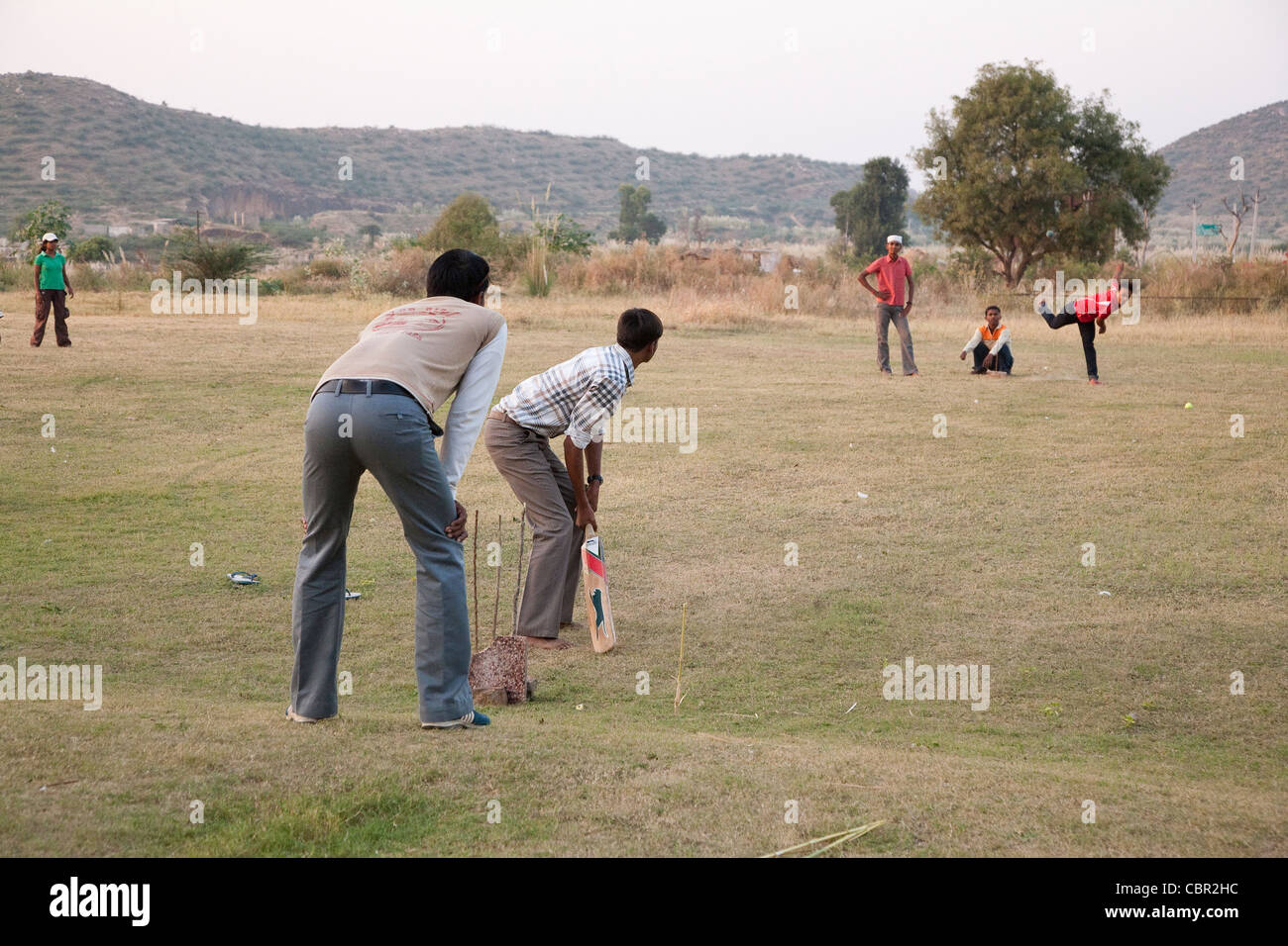 Children and staff playing cricket on a field trip from the Udayan Campus Stock Photo