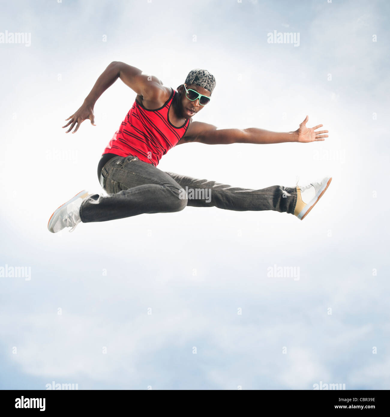 African American man jumping in mid-air Stock Photo