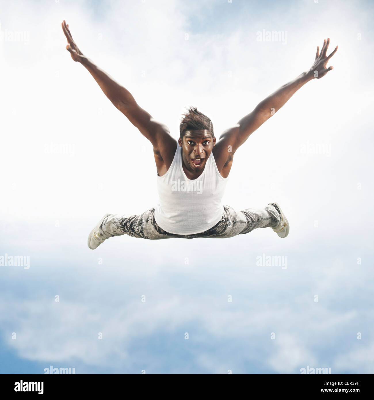 African American man jumping in mid-air Stock Photo