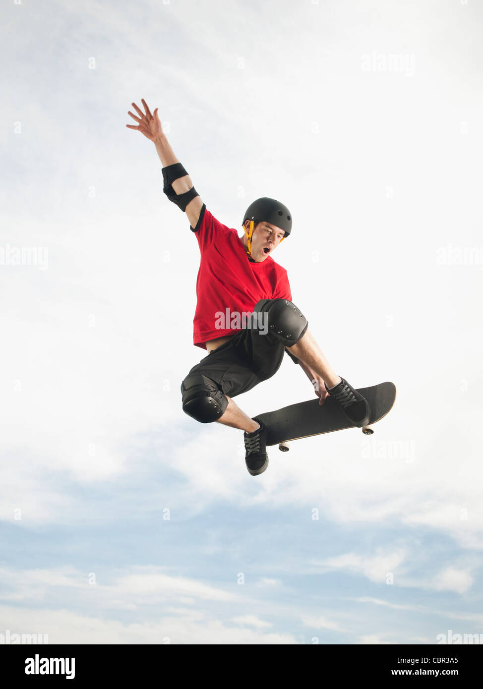 Caucasian man on skateboard in mid-air Stock Photo