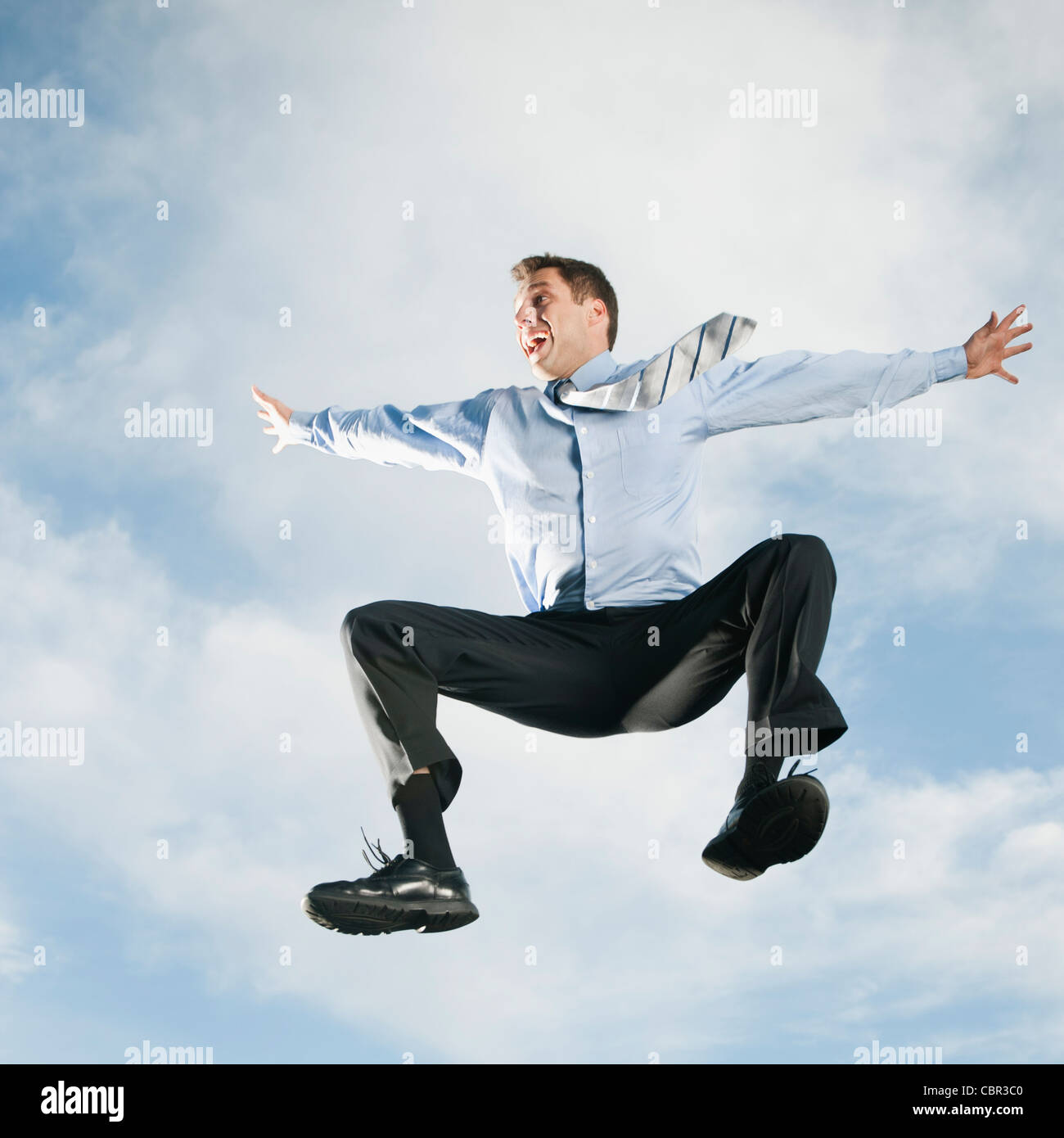 Caucasian businessman jumping in air Stock Photo